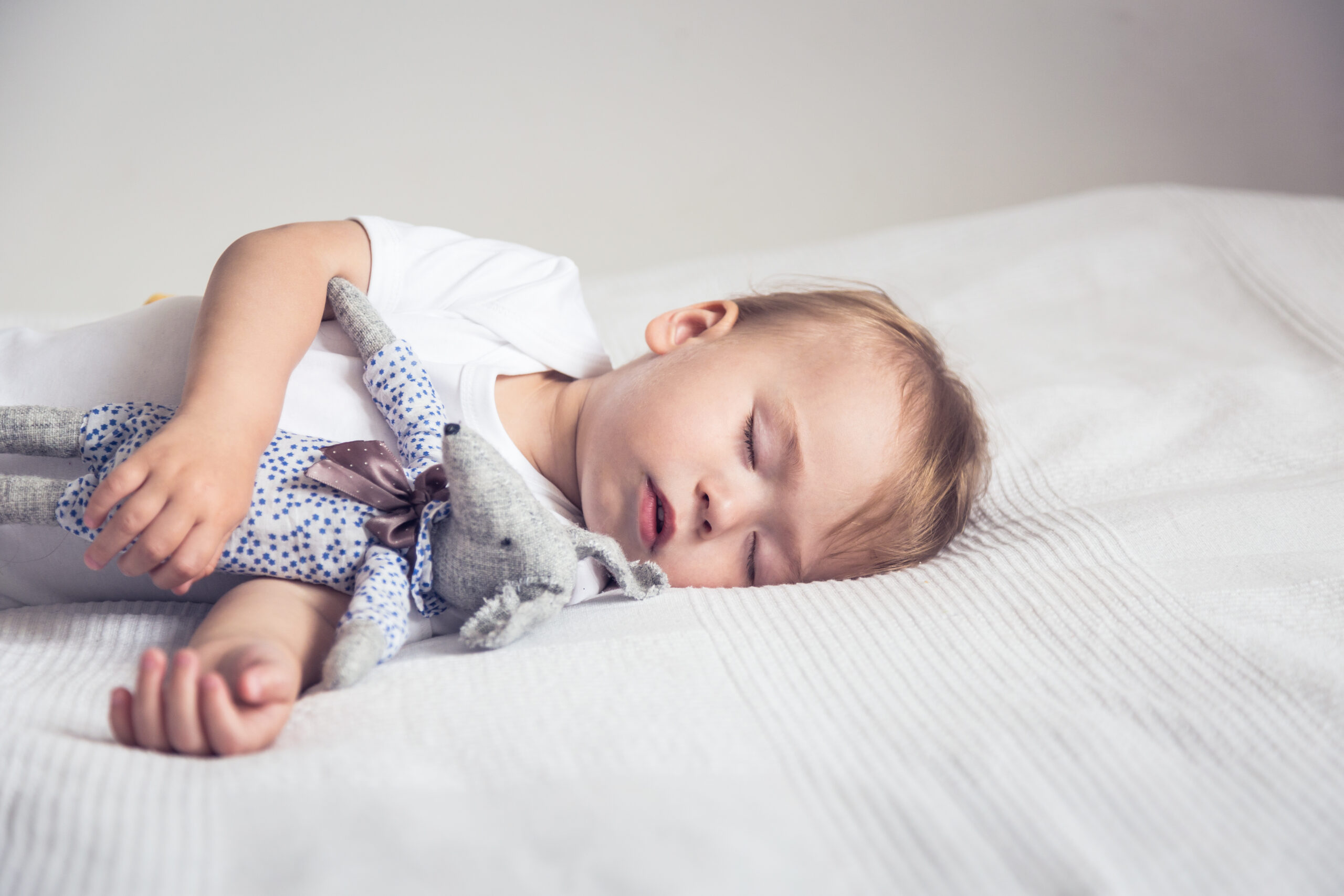 Sleeping,Baby,In,Bed,,Holding,A,Teddy,Bear.
